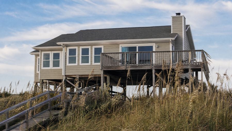 Raised Folly Beach house with new windows and sliding doors